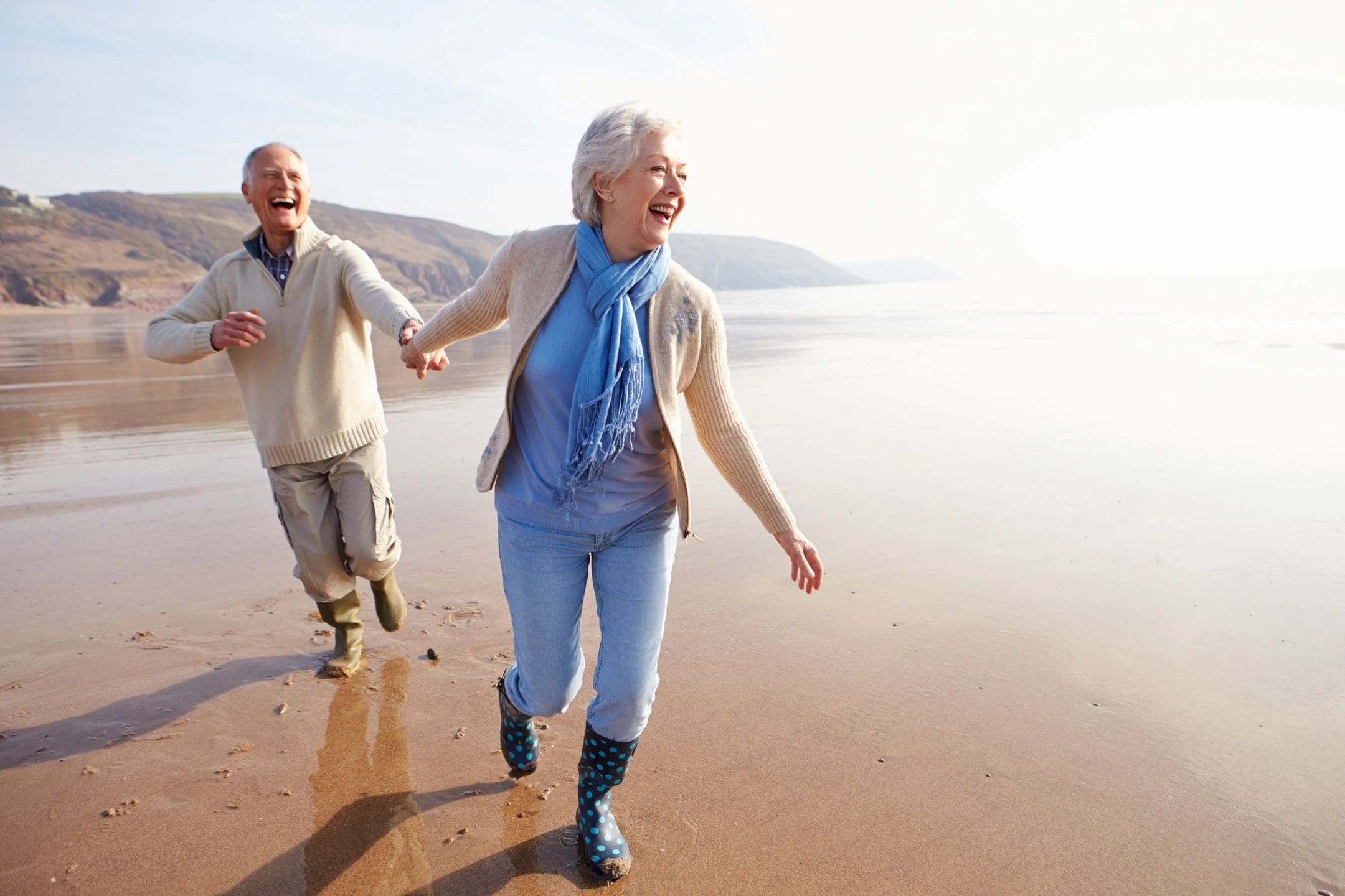 A man and woman walking on the beach